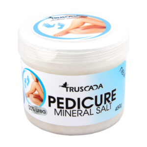 Silky smooth pedicure mineral salt in a white and blue container, ideal for nourishing foot care routines.
