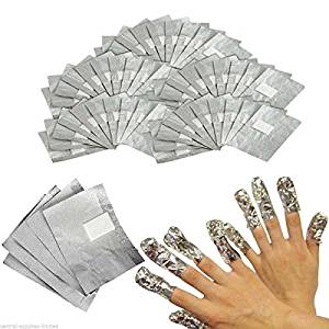 Multiple sheets of Truscada orthodontic material and metallic finger covers used in dental procedures.